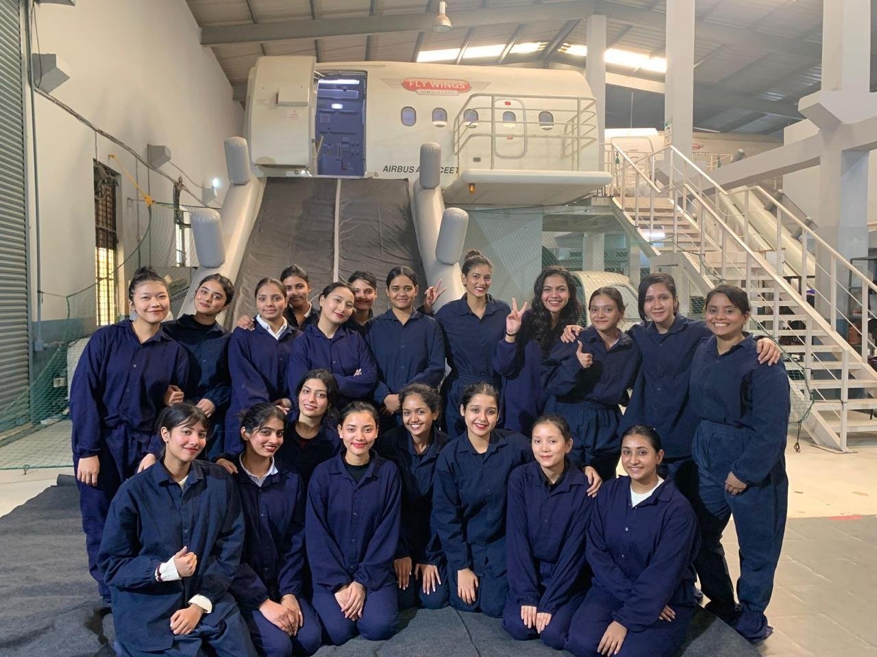 Aviation management students at an aircraft cabin simulator